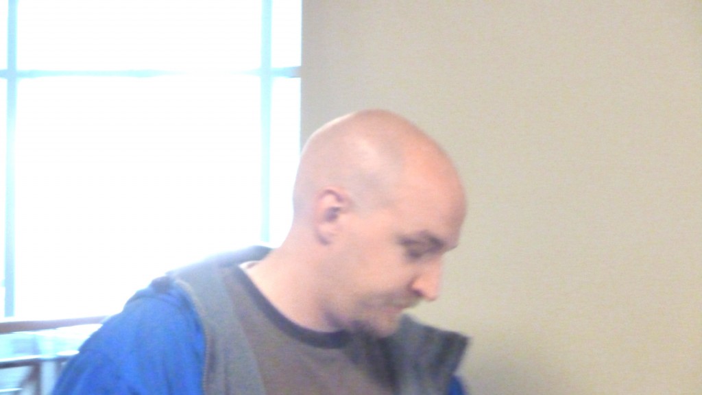 Oliver Doss waits in Courthouse Hallway for Christina who now calls April and Oliver 'mom' & 'dad' on her facebook page