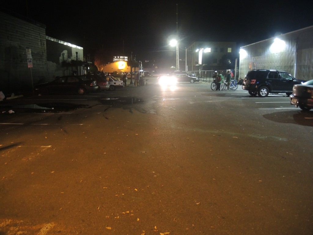 What appears to be a hypodermic needle/syringe can be seen near the center-lower-left of this picture, along with the debris, taken in the heart of Olympia's tenderloin. Artesian Parking Lot